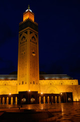 Fototapeta na wymiar Gold artificial lights on Hassan II Mosque and minaret at night in Casablanca Morocco
