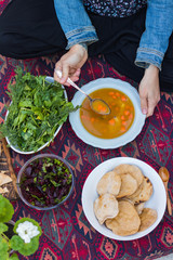 Raw vegan vegetarian diverse assorted mix lunch, dinner on summer table kitchen. Soup, beetroot salad, flatbread, green herbs