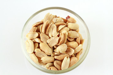 Peanuts in a glass bowl isolated on white background. High protein, 