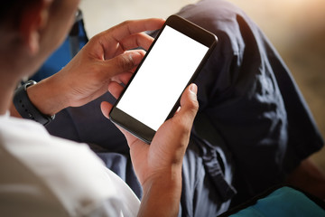Cropped shot view of man hands holding smart phone with blank copy space screen for your text message or information content, female reading text message on cell telephone during in urban setting.
