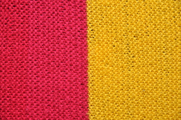 Fibrous texture of woolen fabric. Yellow and red. Background