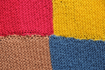 Fibrous texture of woolen fabric. Yellow, blue, brown and red. Background