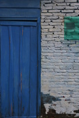 Textured brick walls and worn doors are perfect for background