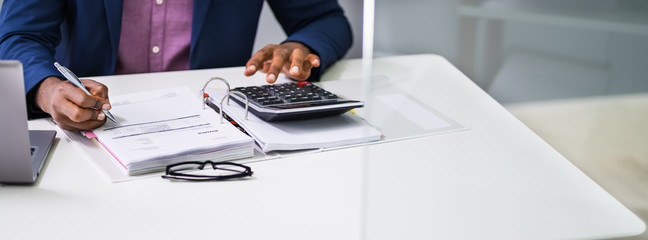 Businessman Calculating Tax