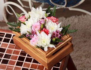 Bouquet of summer flowers in a wooden box