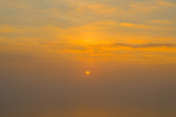 Gorgeous scenic of the strong sunrise with silver lining and cloud on the orange sky
