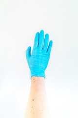 Obraz premium Hand in blue medical glove on white background.