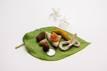 Hindu Puja with betel leaf, supari, janeu, almond, dates, turmeric, dried coconut and jaggery with 1 rupee coin. Important item in Vedic rituals. selective focus