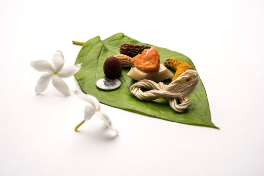 Hindu Puja with betel leaf, supari, janeu, almond, dates, turmeric, dried coconut and jaggery with 1 rupee coin. Important item in Vedic rituals. selective focus