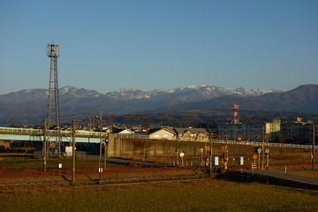 Autumn Tateyama seen from the town over rice fields, Japan (秋の立山)