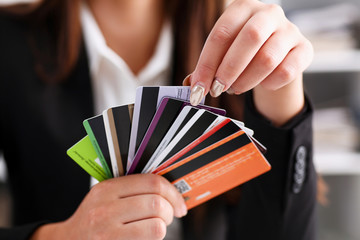 Female arm hold bunch of credit cards picking one closeup. Convenient set of funds, budget wallet...
