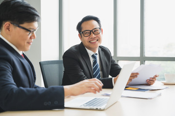 Asian business people team analyzing statistics financial. Team of businesspeople Meeting Conference Discussion Corporate Concept in office.