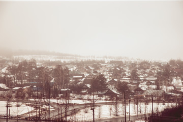 hillside village hiding in dense fog