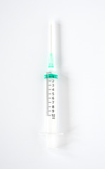 Empty transparent plastic syringe size 10 ml. on white background with space for text. A tube for sucking in and ejecting liquid in a thin stream. Healthy care,medical and beauty object concept.