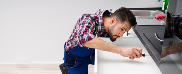 Carpenter Fixing Drawer In Kitchen