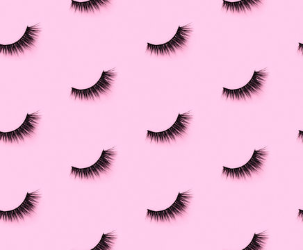 Pattern with eyelashes on pink background.  Flat lay top view