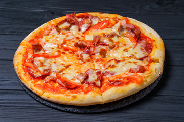 Delicious pizza on wooden table. Food delivery