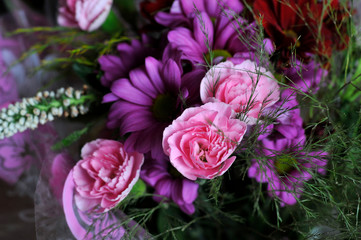 Bouquet of flowers: pink carnations, purple daisies or chrysanthemums.