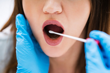 Close-up Of A Doctor Taking Saliva Sample For DNA Test