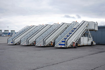 A row of gangways for boarding and alighting passengers from an airplane parked at the airport.