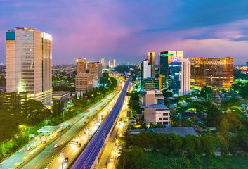 Fototapeta na wymiar Jakarta, Indonesia - 30th December 2018: South Jakarta Cityscape at sunset, with beautiful pastel colored sky. Rail track construction is visible in the foreground.