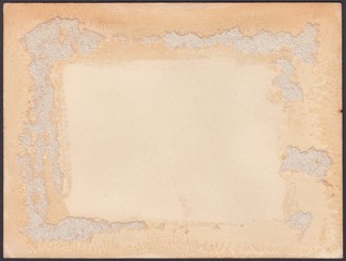 Reverse side of an old photo with traces of glue and paper remnants, background
