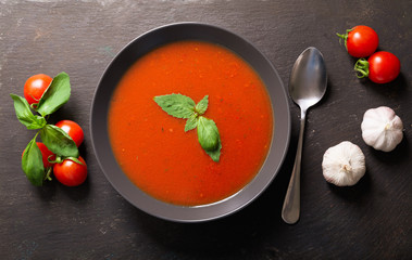 bowl of tomato soup with basil, top view