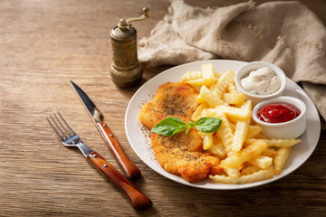 plate of chicken schnitzel and french fries