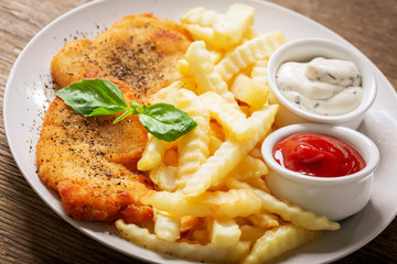 plate of chicken schnitzel and french fries