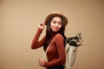 Backpack with flowers. Creative fashion portrait of beautiful y