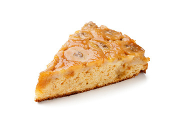 Slice of upside down banana caramel cake isolated on white background