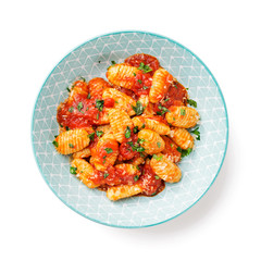 Homemade italian gnocchi with red tomato sauce and parmesan cheese isolated on white background. top view