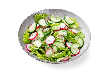 Vegetarian vegetable salad of radish, cucumbers, lettuce .  Healthy vegan food. isolated on white background