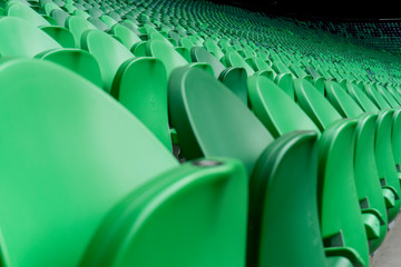 Empty plastic seats in a stadium. Matches to be played without fans.