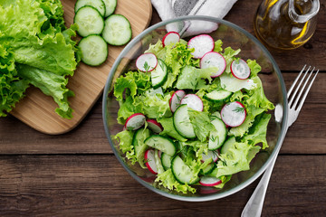 Vegetarian vegetable salad of radish, cucumbers, lettuce .  Healthy vegan food.