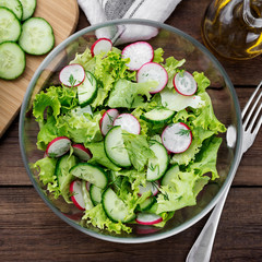 Vegetarian vegetable salad of radish, cucumbers, lettuce .  Healthy vegan food.
