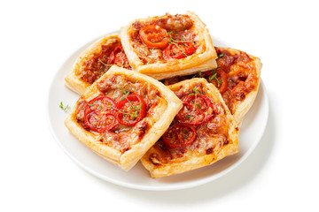 Puff pastry mini pies with cheese and tomatoes isolated on white background