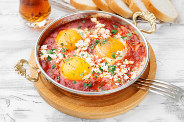 Shakshuka (menemen) fried eggs in tomato sauce for turkish breakfast.	