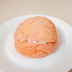 Pink Choux Buns (profiteroles) with Craquelin filled cream. French dessert