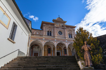 Fototapeta na wymiar Close up front view of Madonna del Sasso church above Locarno city oa sanctuary and pilgrimage church in Orselina, in autumn on sunny day with blue sky cloud, Canton of Ticino, Switzerland