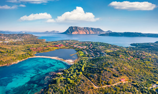 View from flying drone. Astonishing summer scene of Salina Bamba beach with Tavolara mountain on background. Spectacular morning view of Sardinia island, Italy, Europe.