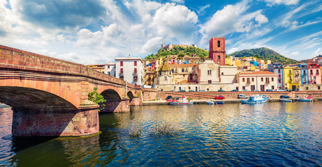 Fototapeta na wymiar Magnificent summer cityscape of Bosa town with Ponte Vecchio bridge across the Temo river. Spectacular morning view of Sardinia island, Italy, Europe. Traveling concept background.