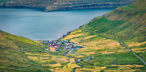 View from flying drone. Splendid morning view of Funningur village, Faroe Islands, Kingdom of Denmark, Europe. Calm summer scene of Eysturoy island. Traveling concept background..