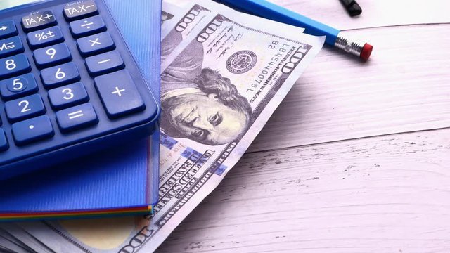 top view of cash , calculator and notepad on table 
