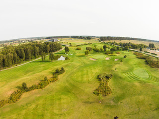 Aerial view of a golf course with green grass