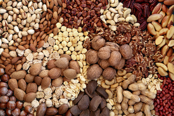 Dried nut collection forming a background. Health food high in protein, omega 3, antioxidants, minerals and vitamins. Can help reduce cholesterol and are beneficial for type 2 diabetes. Flat lay.