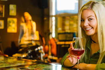 Girl with alcohol glass in pub club