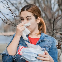 Sick girl. Allergy concept. Seasonal allergy for something, woman with paper napkin