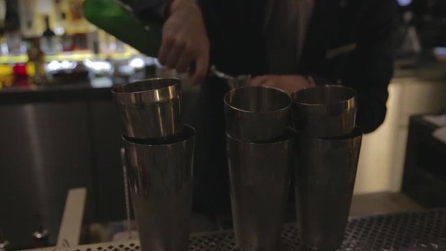 bartender in suit mixing a cocktail