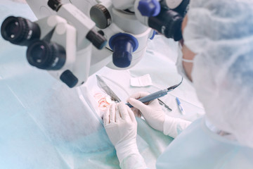 Ophthalmology operation. Surgeon's hands performing laser eye vision correction or cataract...